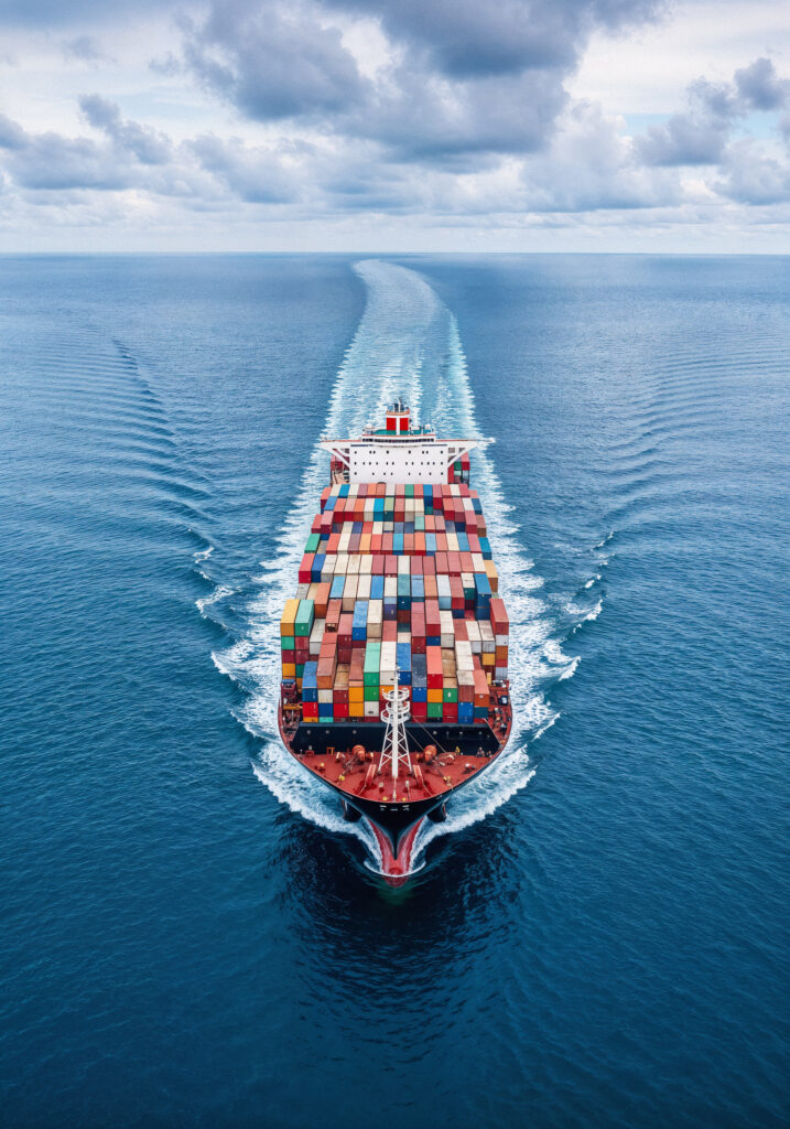 Cargo Ship Sailing Through Ocean 717x1024